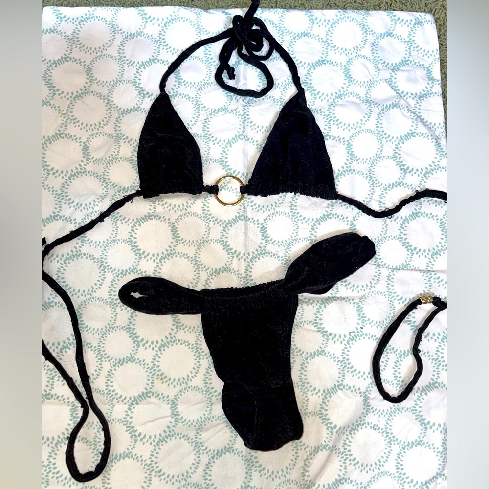 Eye lit black bikini no side tie bottoms with gold embellishment. Isme swim